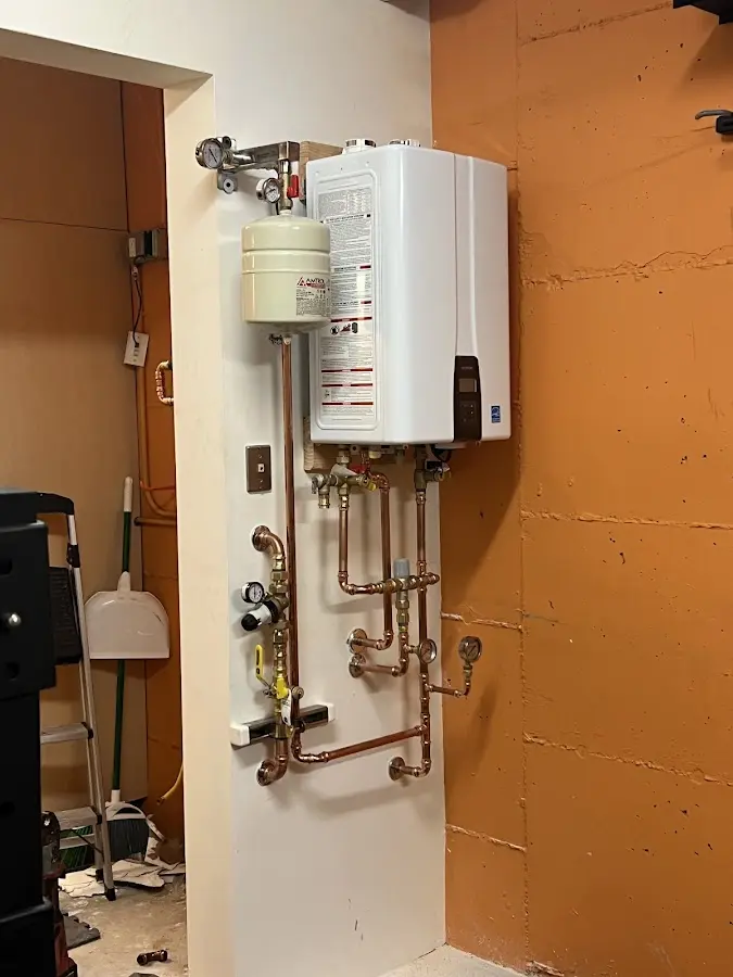 Plumbing technician inspecting water heater connections in Nyack